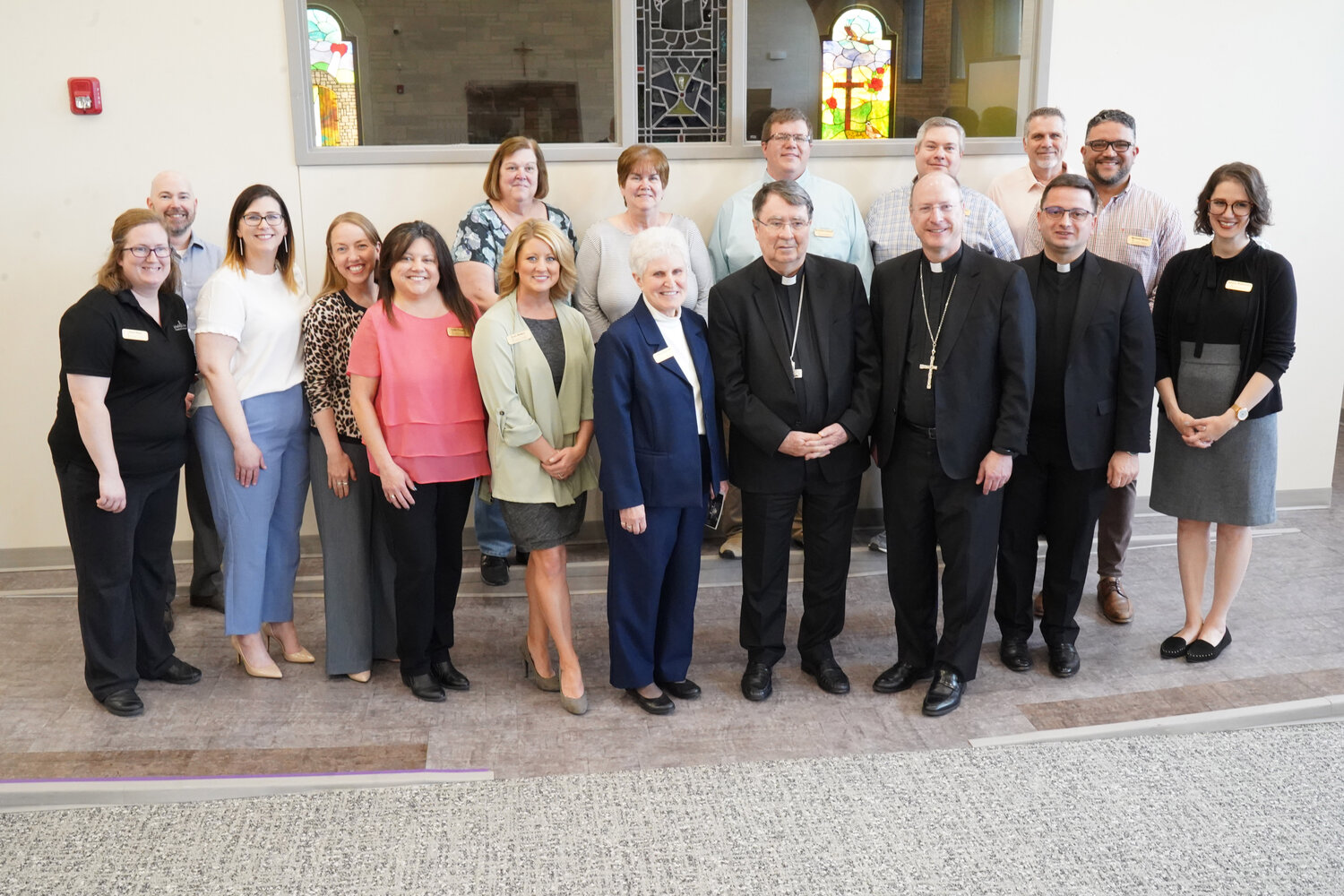 Archbishop Christophe Pierre, apostolic nuncio to the United States, joins Bishop W. Shawn McKnight, Sister Kathleen Wegman SSND, interim executive director, and members of the Catholic Charities of Central and Northern Missouri staff for a photo while touring the Catholic Charities Central Offices on May 4.